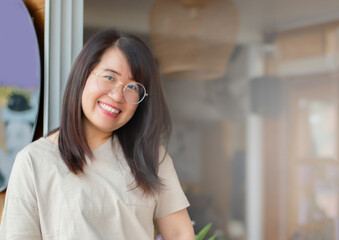 Fototapeta premium portrait of young adult business woman standing near the door of her own cafe, soft focus.