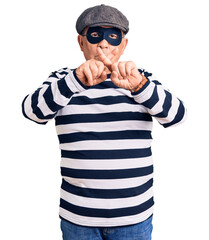 Senior handsome man wearing burglar mask and t-shirt rejection expression crossing fingers doing...