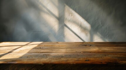 Empty wooden table with a soft morning light casting gentle shadows
