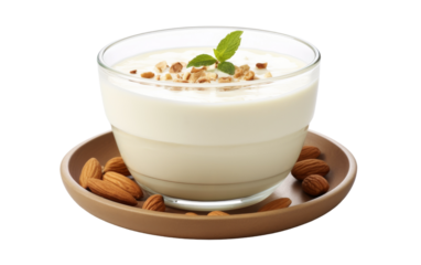A bowl filled with creamy yogurt topped with an assortment of crunchy nuts on a white plate