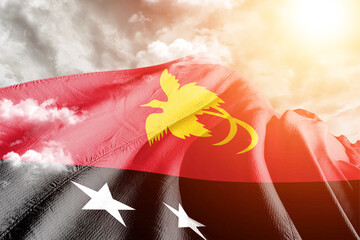 Papua New Guinea  national flag cloth fabric waving on beautiful cloudy Background.