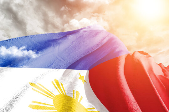 Philippines national flag cloth fabric waving on beautiful cloudy Background.