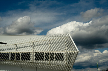 Modern architecture, building with a steel lattice facade, with sharp edges, beautifully shaded by...