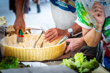hands preparing traditional cheese at a street food market
