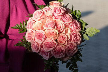 vibrant bouquet of pink roses cradled in elegant fuchsia fabric