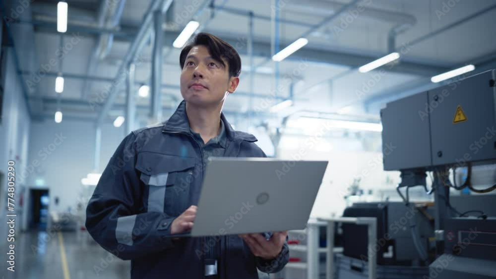 Leinwandbilder asian engineer using a laptop computer on the go at electronics manufacturing factory. adult technic