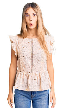 Beautiful caucasian woman with blonde hair wearing elegant summer clothes scared and amazed with open mouth for surprise, disbelief face