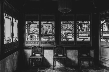 Naklejka premium Historic Chinese style building in Asia. Ancient historic wooden mansion in the center of the Asian capital Taipei. Interior old historic house in black and white with natural sun light Taipei Taiwan.