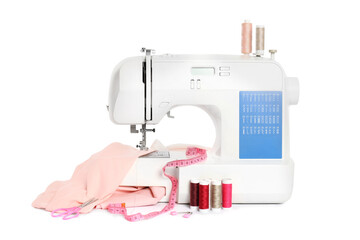 Modern sewing machine with pink cloth and craft accessories isolated on white