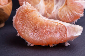 peeled red and pink pomelo on the table