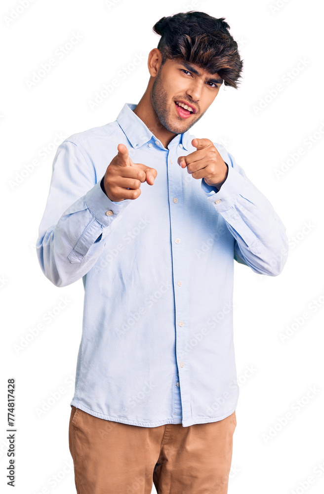 Canvas Prints young hispanic man wearing casual shirt pointing fingers to camera with happy and funny face. good e