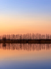 Fototapeta premium winter sunset on the lake after the ice melts