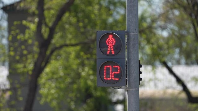 regulations and driving safety. Traffic light on the road regulates traffic. vertical traffic light with blue sky and high-rise buildings in the background. A traffic light above the road.