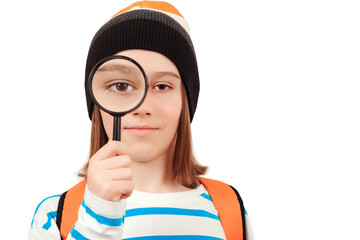 Boy looking through magnifying glass. Schoolboy holding the magnifying glass. Children's interest. Portrait of student boy with magnifier.