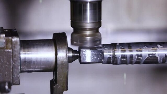 CNC turning machine throwing coolant liquid on metal tool component high precision in shaping forming process by computer numerical control automation milling workpiece using a rotating cutting tool	