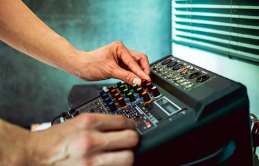 Sound engineer hands adjusting control sound mixer in recording, broadcasting studio,Sound mixer....