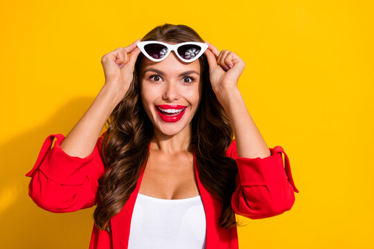Photo of young excited lovely lady surprised wow good news eyeglasses isolated over yellow color background