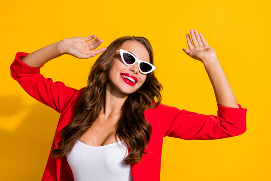 Photo of young excited girl have fun eyeglasses carefree dance clubber isolated over yellow color background