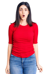 Fototapeta premium Young beautiful girl wearing casual t shirt scared and amazed with open mouth for surprise, disbelief face