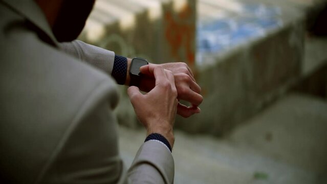 Male checking pulse on smartwatch App	