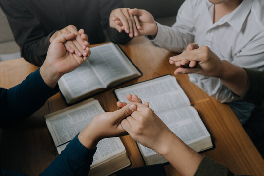 Christian group holding hands pray and worship god together on the sunday morning.spirituality, religion,believe.Christian life.Studying the word of God in church.