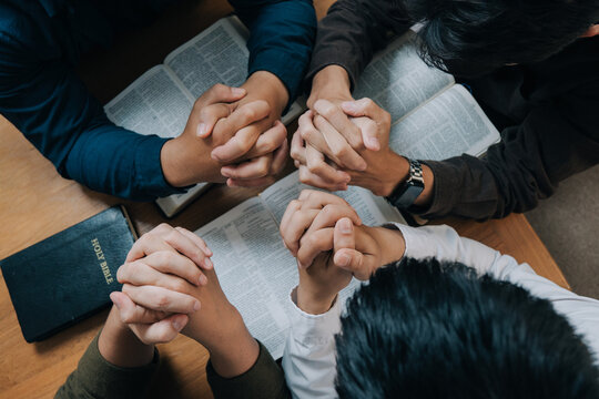 Group of christian people reading the Holy Bible to pray and worship God together in the sunday morning.spirituality, religion,believe.Christian life.Studying the word of God in church.