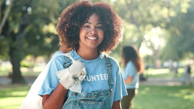 Trash bag, face and black woman for volunteer work, recycling or cleaning of park for nature and sustainability. Female person, gen z girl and environmentalist in garden by tree, plant and community