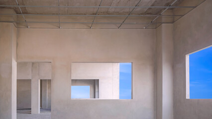 Interior concrete wall rooms structure of incomplete office building with blue sky view inside of...