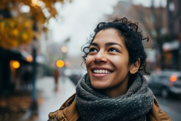 Portrait of a smiling young woman in a city street in autumn