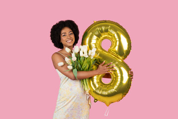 Woman with number 8 balloon and tulips smiling