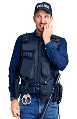 Young handsome man wearing police uniform looking stressed and nervous with hands on mouth biting nails. anxiety problem.