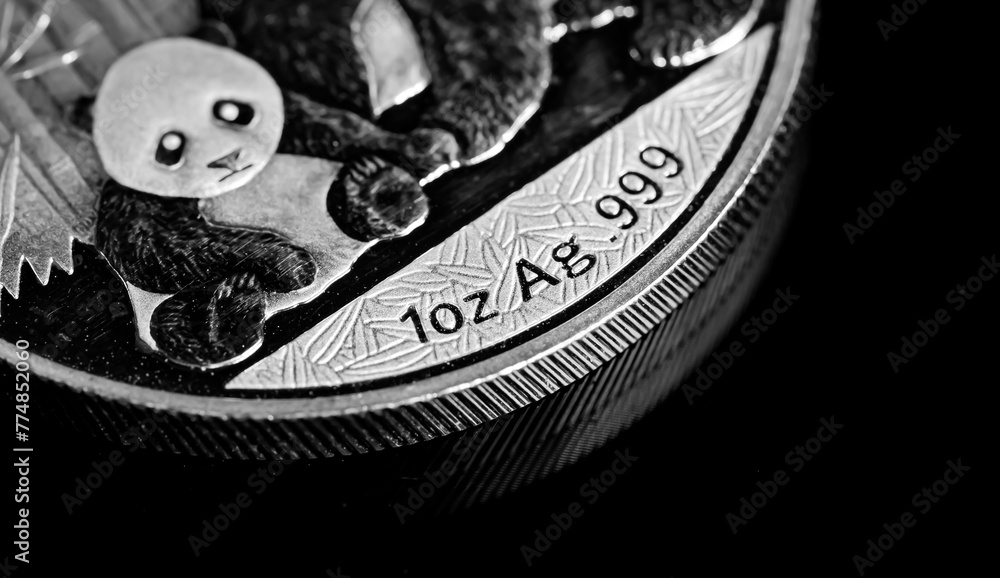 Wall mural Close up of  Silver Bullion Coin on a black mirror background