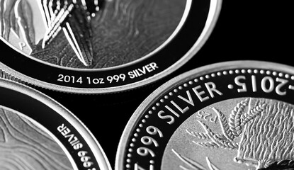Close up of  Silver Bullion Coin on a black mirror background