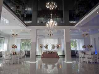 Interior of a wedding hall with a chandelier and chairs