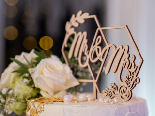 wedding cake with white roses on the background bokeh