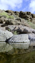 Large stones emerge from the surface of the pond. Climate change concept