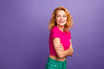 Photo of positive adorable woman wear trendy pink clothes crossed arms empty space isolated on purple color background