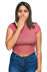 Young hispanic girl wearing casual t shirt bored yawning tired covering mouth with hand. restless...
