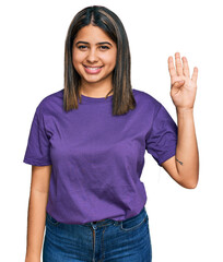 Young hispanic girl wearing casual purple t shirt showing and pointing up with fingers number four...