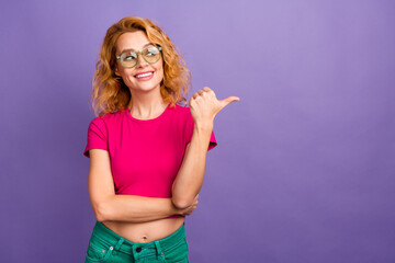 Plakaty  Photo of charming cheerful cute woman wear trendy pink clothes look empty space isolated on purple color background