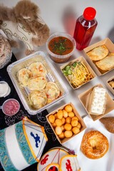 Delectable Uzbek Food with Traditional Decor and Drink on a White Background