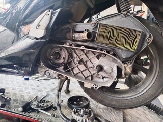 the continuously variable transmission (CVT) part of a motorbike is being dismantled to be repaired...