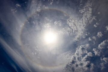 halo of the sun with clouds in the sky