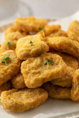 Delicious golden chicken nuggets on a plate close up. Fast food, menu.