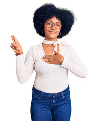 Young african american girl wearing casual clothes and glasses smiling swearing with hand on chest...