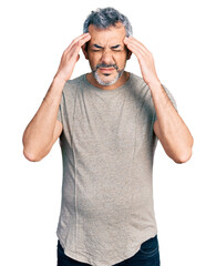 Naklejka premium Middle age hispanic with grey hair wearing casual grey t shirt with hand on head for pain in head because stress. suffering migraine.