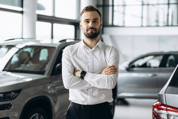 Business man in car showroom choosing a car