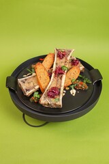 Beef Bone with Herbs and Spices on Black Plate with Copy Space