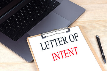 LETTER OF INTENT text on clipboard on laptop
