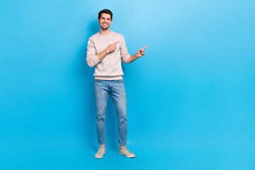 Full length photo of positive good mood guy dressed white pullover indicating at offer empty space...